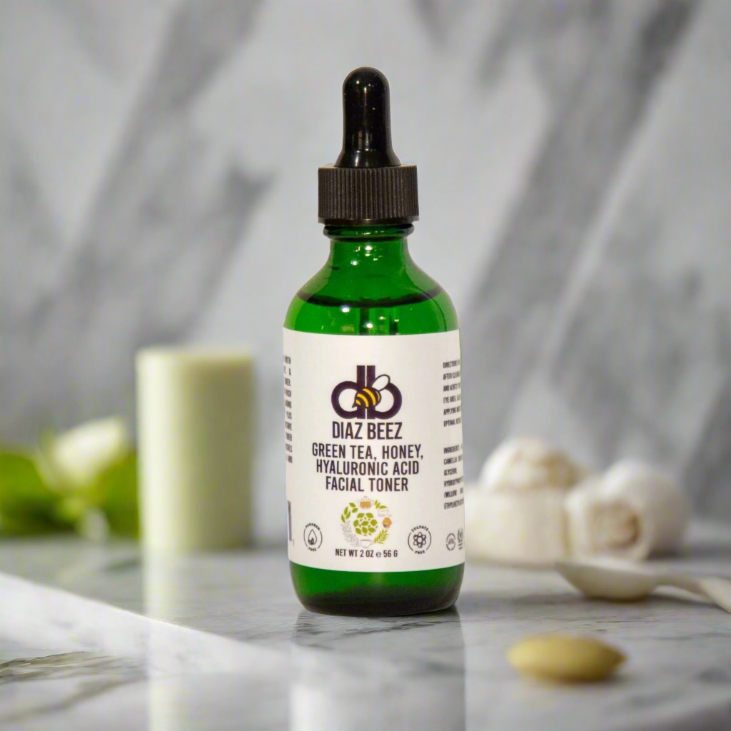 Diaz Beez Green Tea, Honey, Hyaluronic Acid Facial Toner bottle on a marble surface with a dropper cap.